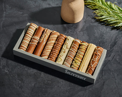 A beautifully arranged mini chocolate log tray featuring rich, hand-dipped chocolates. Perfect for gifting or indulging in a premium chocolate experience.