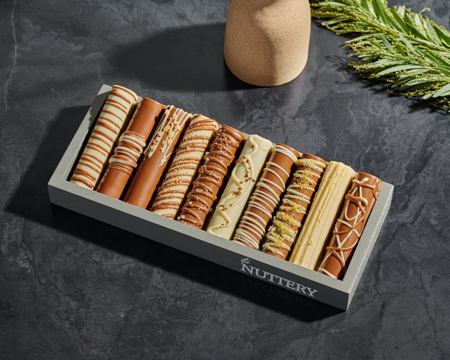 A beautifully arranged mini chocolate log tray featuring rich, hand-dipped chocolates. Perfect for gifting or indulging in a premium chocolate experience.