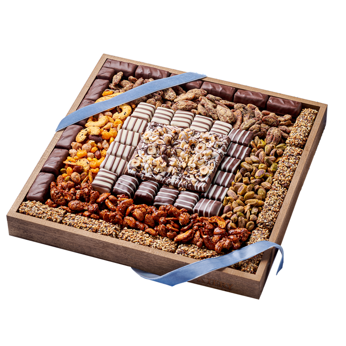 Premium snack tray showcasing layers of chocolates, nuts, and confections in a wooden box, tied with a light blue ribbon for an elegant presentation.