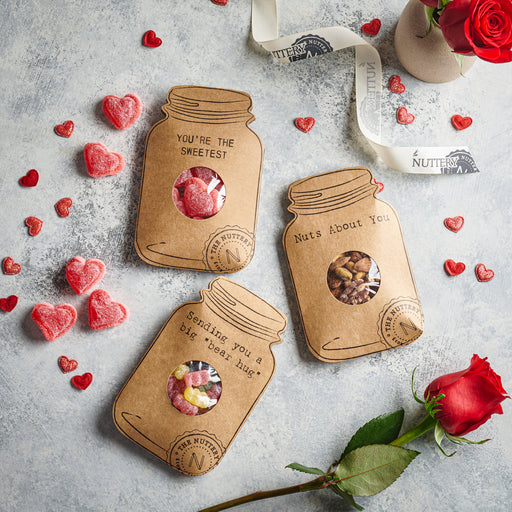Sending You a Big Bear Hug card featuring a jar-shaped design filled with colorful gummy candies, surrounded by red hearts and a rose for a sweet and thoughtful gift.
