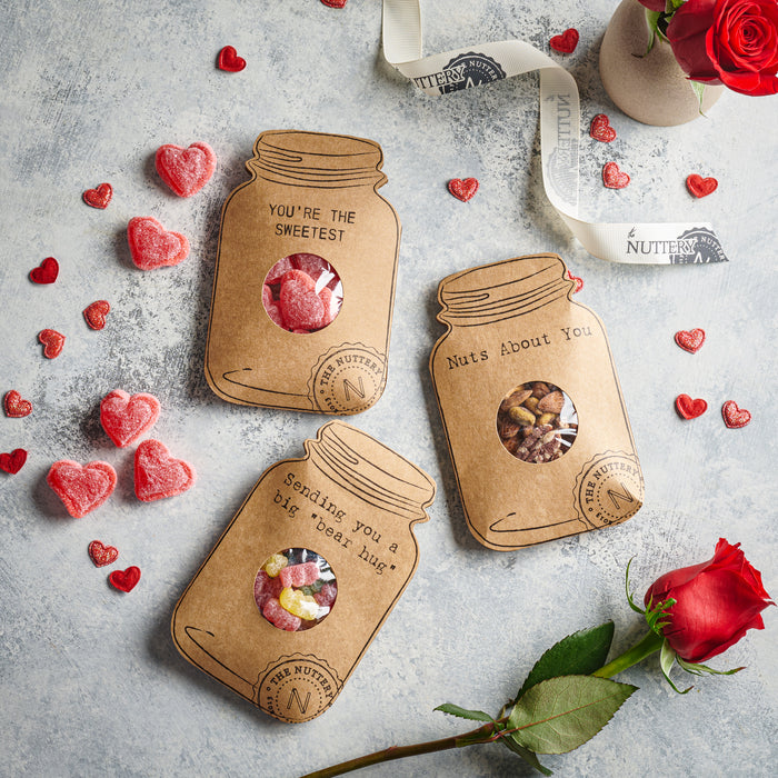Sending You a Big Bear Hug card featuring a jar-shaped design filled with colorful gummy candies, surrounded by red hearts and a rose for a sweet and thoughtful gift.