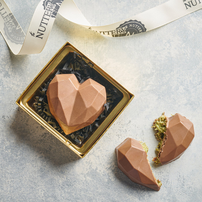 A premium heart-shaped chocolate with a faceted design, encased in a luxurious gold box. Ideal for Valentine’s Day, anniversaries, or any heartfelt occasion.