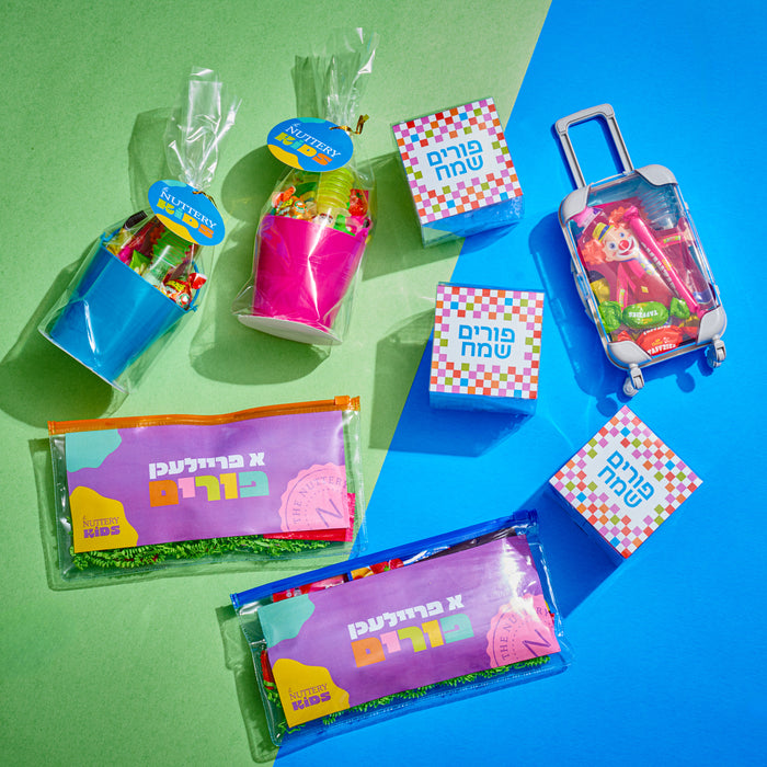 A colorful assortment of Purim-themed candy gift packs, including vibrant treat bags and a mini suitcase filled with sweets. A fun and festive gift for children celebrating Purim.