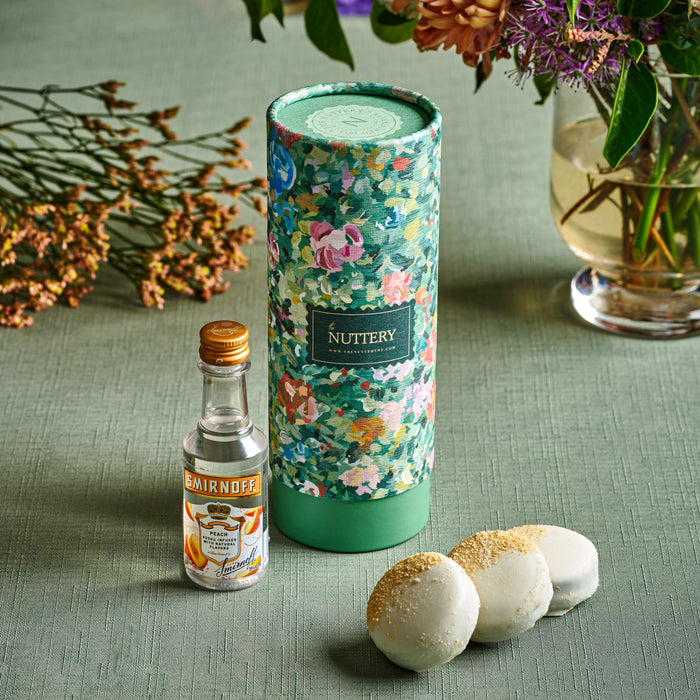 A high-end floral-themed gift tube packed with handcrafted sweets and a premium mini Smirnoff vodka bottle. Perfect for those who appreciate elegant gifting with a modern twist, this gourmet set makes a lasting impression.