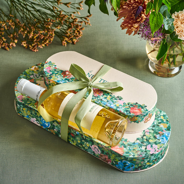 This premium floral gift box set includes a beautifully designed tin and a bottle of white wine, making it a sophisticated gift for anniversaries, corporate events, and special celebrations. A perfect pairing of luxury and indulgence.