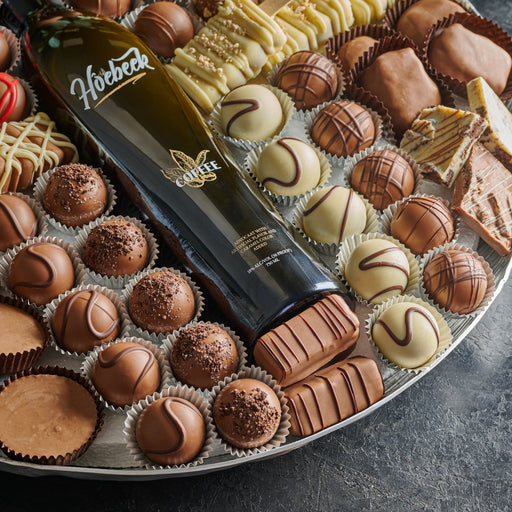 A luxurious assortment of dairy chocolate truffles and pralines, handcrafted for the ultimate indulgence. Each piece is coated in velvety chocolate with intricate designs.