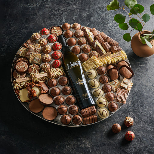 An exquisite chocolate platter featuring an assortment of gourmet dairy chocolates, pralines, and confections. Ideal for elegant gifting or special celebrations.