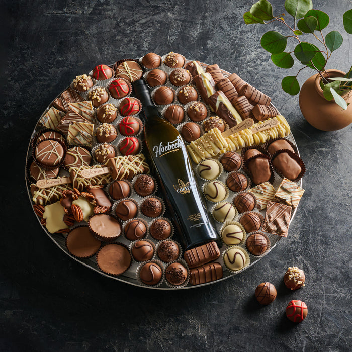 An exquisite chocolate platter featuring an assortment of gourmet dairy chocolates, pralines, and confections. Ideal for elegant gifting or special celebrations.