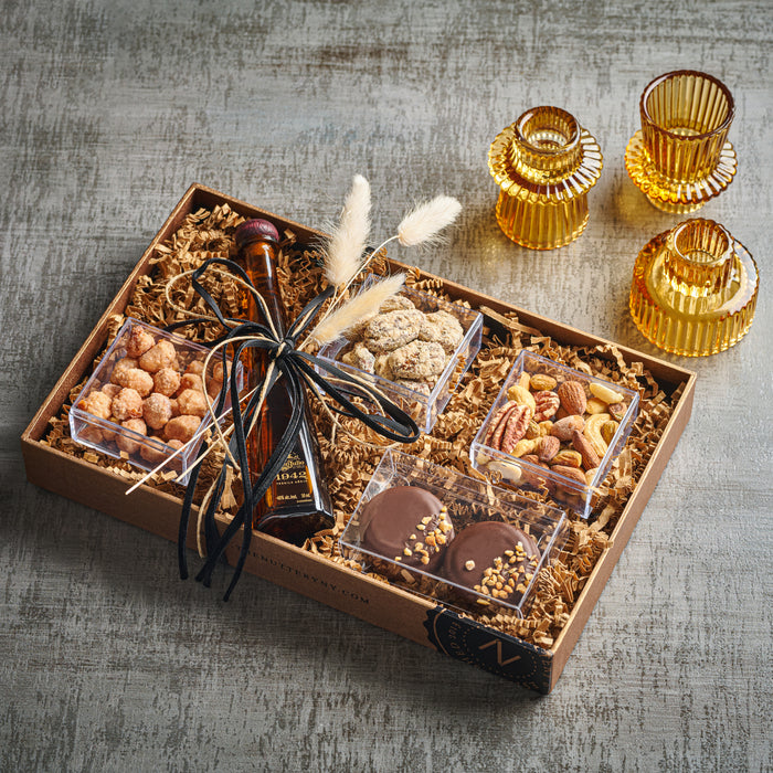 A luxurious chocolate and nut gift tray featuring a premium bottle for an elegant touch. A perfect gift for special celebrations and gourmet indulgence.