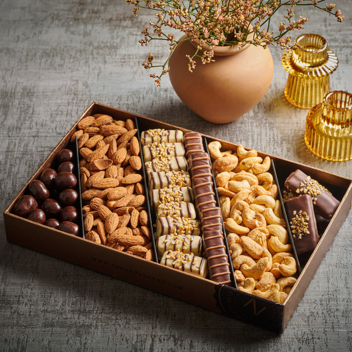 A luxurious gift tray of premium nuts and chocolate-covered treats, beautifully arranged for any celebration. Featuring crunchy almonds, cashews, and decadent chocolate delights, this set is an elegant indulgence.