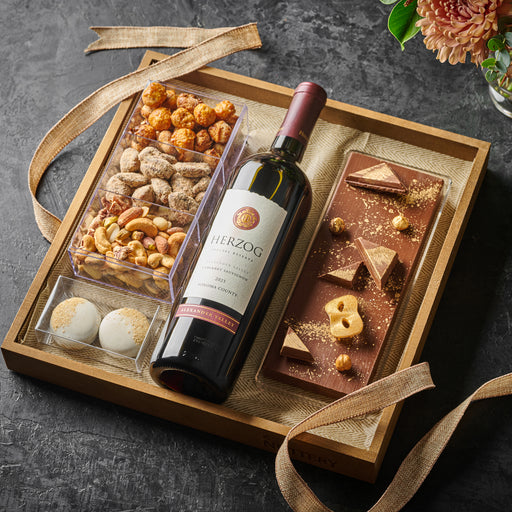 A luxury wine gift tray with a curated selection of roasted nuts, gourmet truffles, and a handcrafted chocolate bar, wrapped with a stylish ribbon.