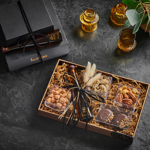 Honey bottles with a nuttery label box and chocolate and nut gift tray featuring a premium bottle for an elegant touch.