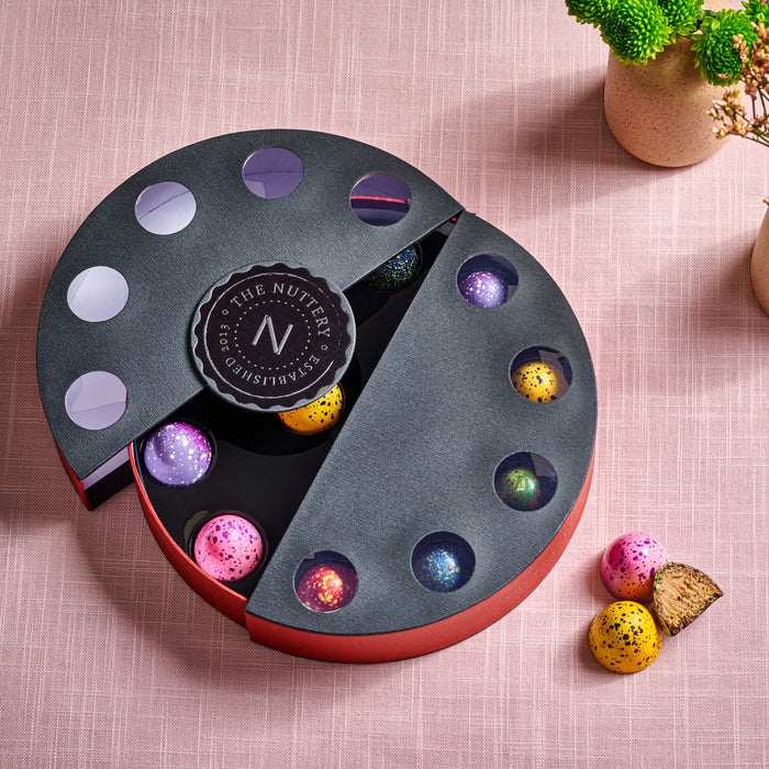 A peek inside this exquisite chocolate box reveals hand-painted truffles with a rich, decadent center. A delightful surprise for those who enjoy gourmet chocolates with artistic flair.