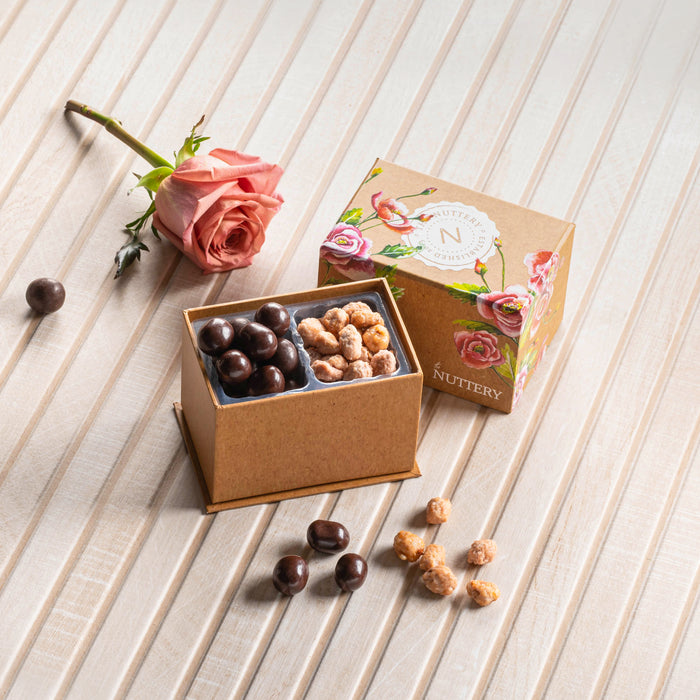 This charming floral-themed gift box from Nuttery is filled with gourmet chocolate-covered nuts and caramelized treats, offering a luxurious snacking experience. The hand-painted floral design adds a touch of sophistication, making it perfect for holidays, weddings, and special occasions.