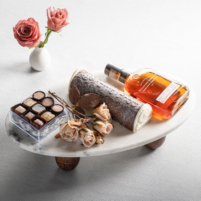 Celebrate Purim in style with The Nuttery's luxurious gift tray featuring premium whiskey, handcrafted chocolates, and elegant floral accents. A perfect holiday indulgence.