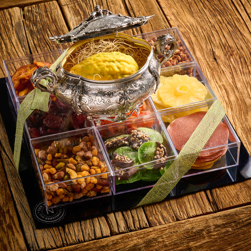 gift tray featuring an extravagant display of dried fruits, including pineapple, apricots, figs, and candied citrus with an esrog on top.