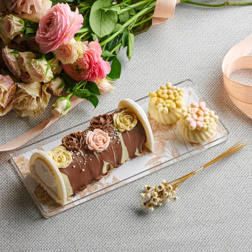 A stunning Shavuos gift tray wrapped in elegance, featuring gourmet chocolates and artisanal sweets, perfect for gifting and festive gatherings.