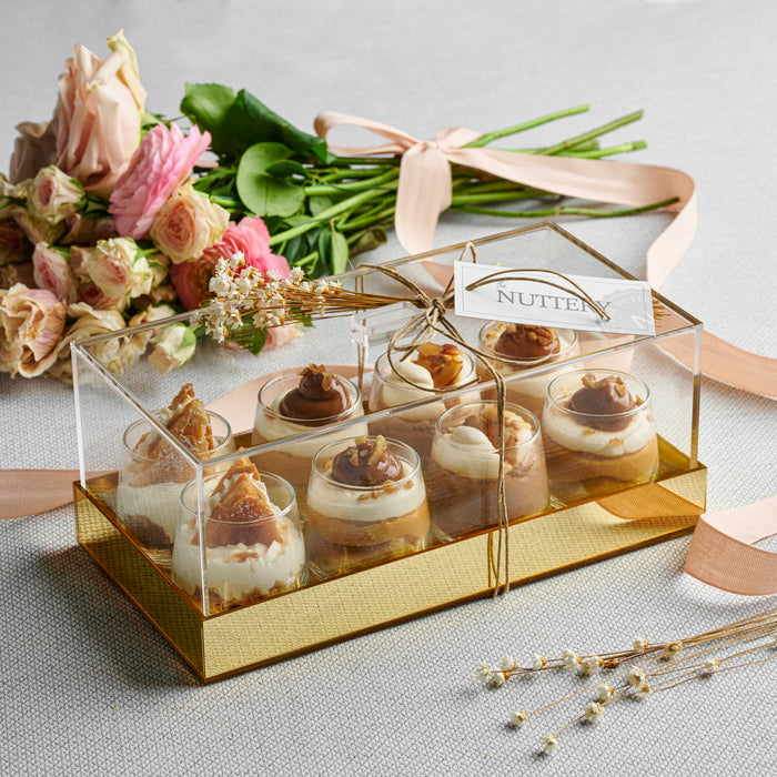 Indulge in a beautifully arranged tray of mousse shot cups, featuring layers of creamy dairy mousse, rich caramel, and nutty toppings. This decadent dessert set makes the perfect centerpiece for weddings, events, and special occasions.
