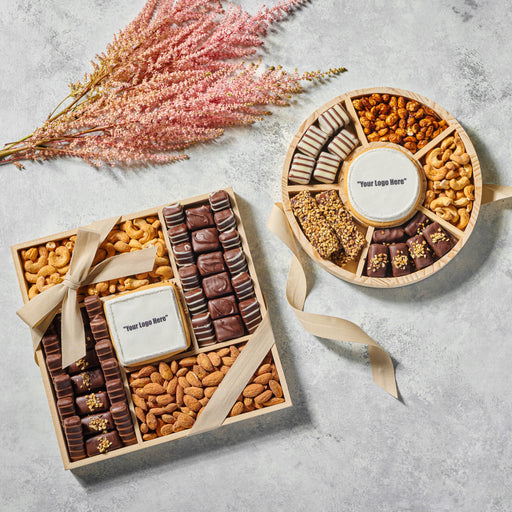 The Nuttery NY custom corporate gift set, offering a beautifully wrapped selection of gourmet chocolates and nuts, designed for personalized branding with a logo-engraved chocolate centerpiece.