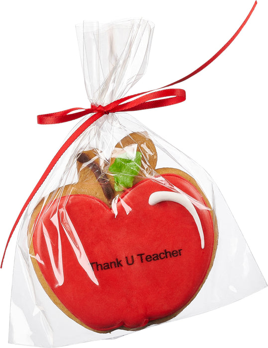 Red apple-shaped cookie with 'Thank U Teacher' text, wrapped in clear plastic and tied with a red ribbon, perfect for teacher appreciation gifts from The Nuttery.