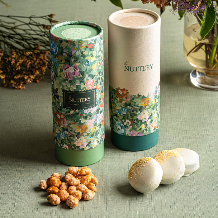 The Floral Delight Gift Tube Set features a stunning cylindrical design, housing a curated selection of chocolate-dipped nuts, caramelized treats, and gourmet confections. A great choice for Shalach Manos, holiday gifts, and luxury celebrations.