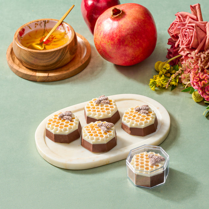 The Nuttery Chocolate Honeycombs – handcrafted honeycomb-shaped chocolates with rich milk and white chocolate layers, decorated with edible bees, perfect for Rosh Hashanah celebrations.