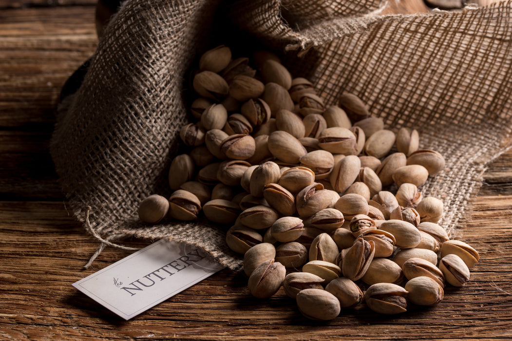 In-shell roasted pistachios lightly salted and stored in a burlap-style sack for Passover celebrations.