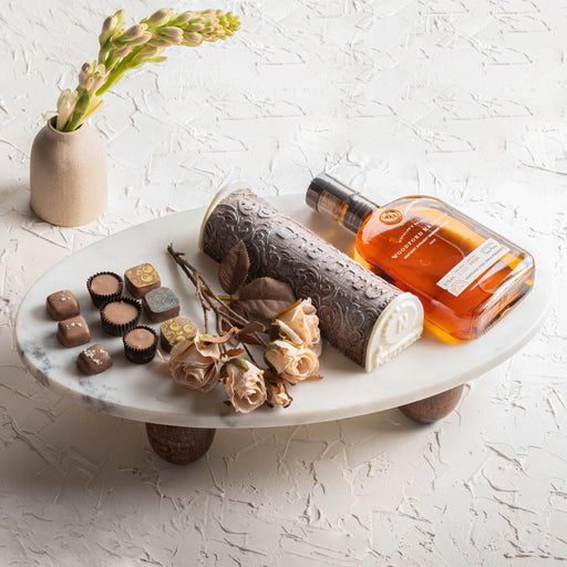 An exquisite Purim gift set featuring smooth whiskey, gourmet chocolates, and beautiful floral decor. Thoughtfully designed for festive celebrations and gifting.