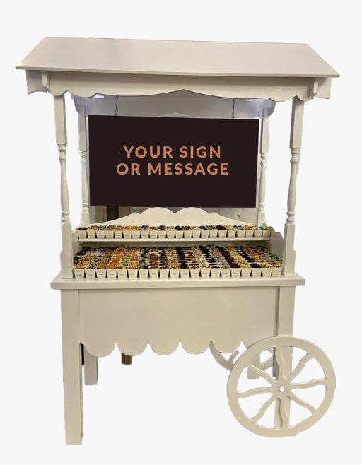 A customizable vintage-style candy cart with space for a personalized sign, filled with gourmet chocolates, nuts, and treats, perfect for events and parties.