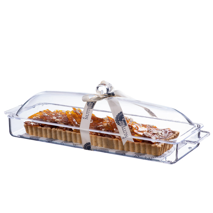 Delicious rectangular tart layered with crispy rolled wafers and white chocolate drizzle, packaged in a clear acrylic serving tray and tied with a branded cream ribbon for gifting.