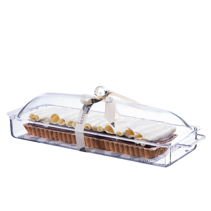 Rectangular tart topped with caramelized almond brittle, presented in a clear acrylic serving tray and tied with a branded cream ribbon, perfect for gifting or dessert tables.