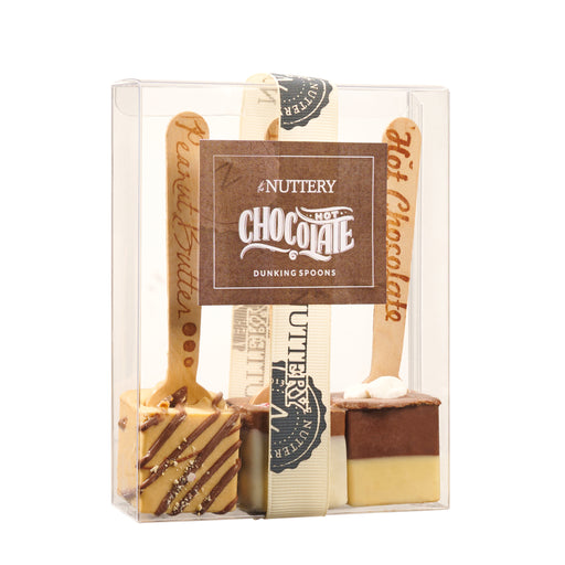 Close-up of Chanukah hot chocolate dippers with engraved wooden stirrers, featuring flavors like peppermint and peanut butter, elegantly packaged for gifting.
