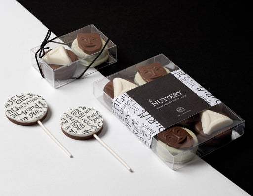 A stylish Purim Oreo gift set, featuring milk and white chocolate-dipped cookies with themed designs. A perfect treat for sharing during the holiday.