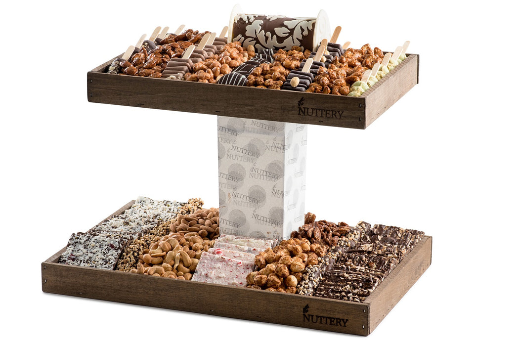 Elegant Nuttery Luxure double-tiered gift tray featuring roasted nuts, chocolate bark, pralines, and specialty chocolate pops, perfect for gifting.