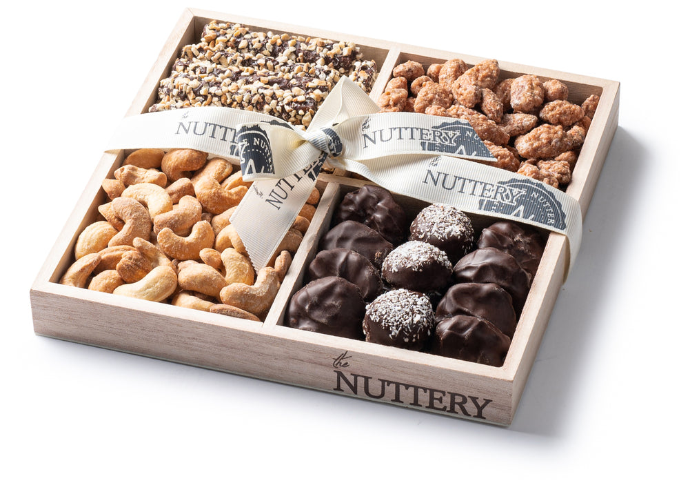 A luxurious four-section Passover gift tray filled with an assortment of gourmet nuts and chocolates, tied with a branded ribbon for a premium presentation