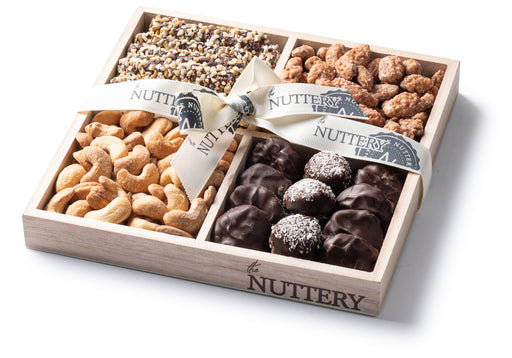 A luxurious four-section Passover gift tray filled with an assortment of gourmet nuts and chocolates, tied with a branded ribbon for a premium presentation