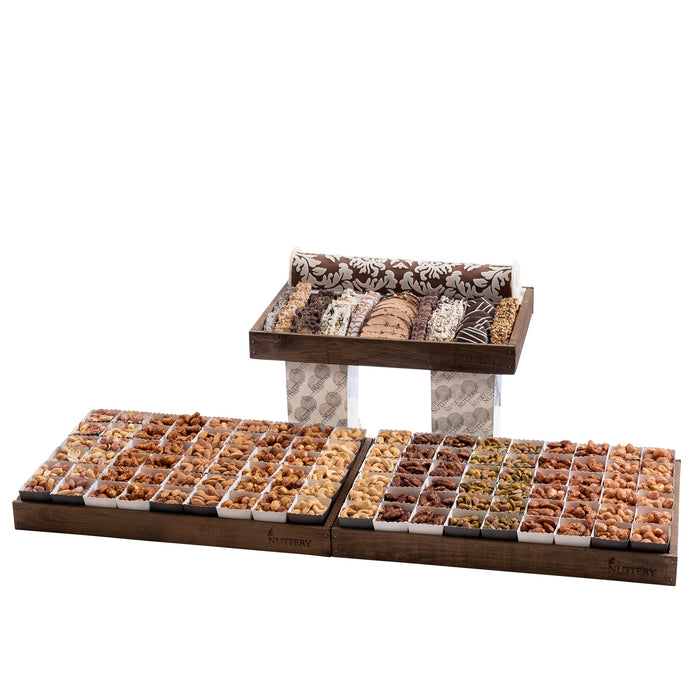 A luxurious three-tiered gourmet display featuring a variety of roasted nuts, premium chocolates, and artisanal confections. Perfect for grand events, corporate gifting, or upscale celebrations