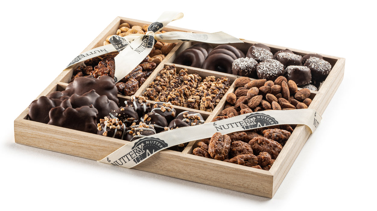 A five-section wooden tray filled with a variety of premium nuts and rich chocolates, elegantly wrapped for Passover gifting and celebrations.