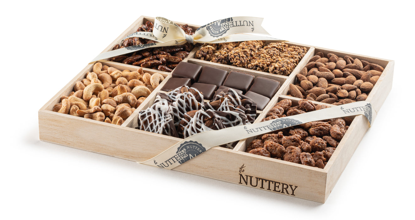 This Kosher for Passover 7 Section Large Chocolate and Nut Platter is a beautifully arranged assortment of premium nuts, rich chocolates, and sweet treats. Perfect for gifting or sharing, it offers a gourmet selection wrapped elegantly with a signature Nuttery ribbon.