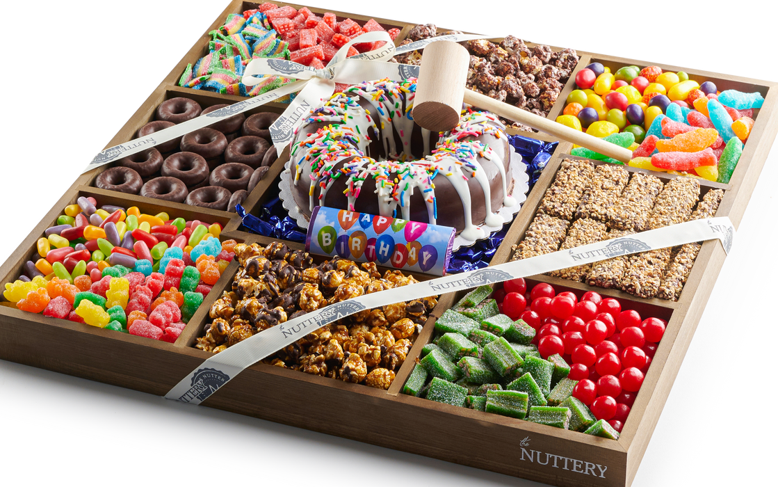Colorful Nuttery Mega Birthday Gift Tray featuring a variety of chocolates, candies, sour treats, gourmet popcorn, and a smash cake centerpiece with a hammer for birthday celebrations.