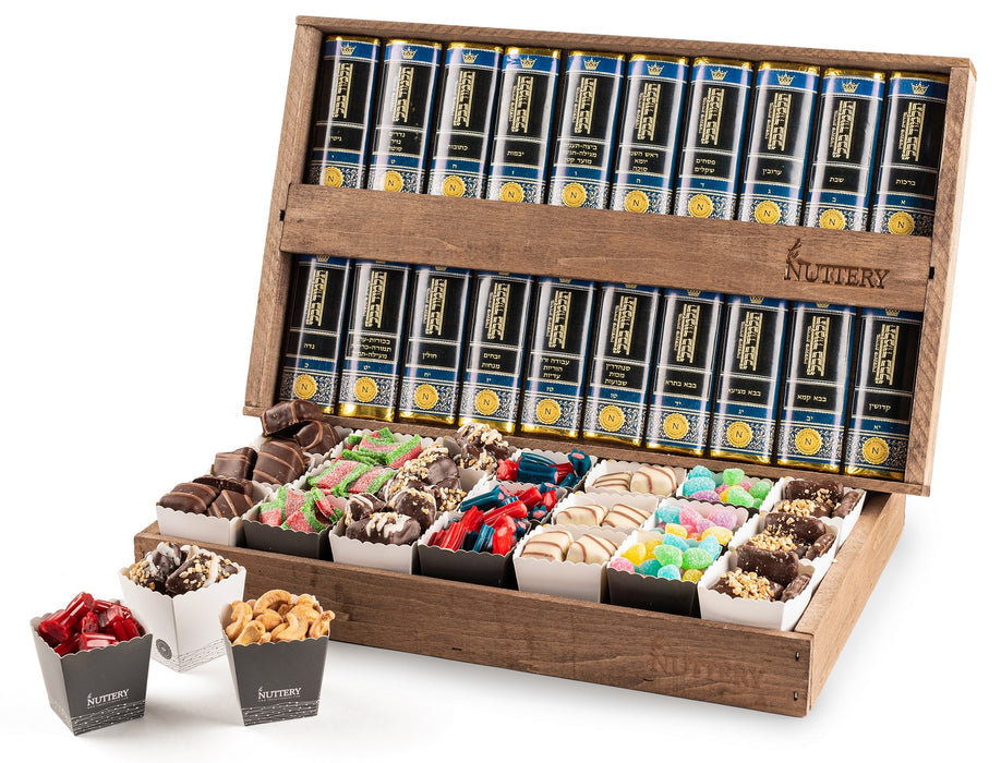 A grand wooden box filled with assorted gourmet chocolates, nuts candy, and spiced treats, paired with a full set of Shas books for an elegant and meaningful gift arrangement