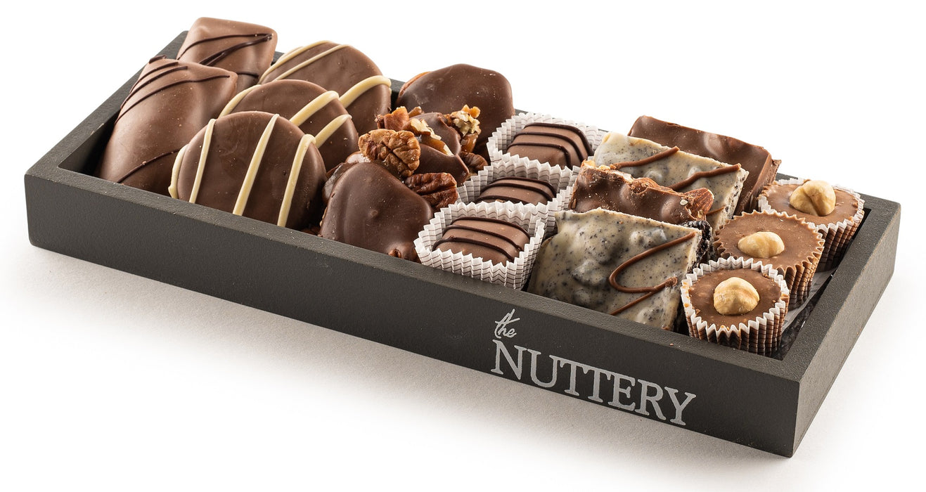 A gourmet chocolate gift tray filled with handcrafted dairy chocolates and nut-infused confections. The perfect elegant gift for any chocolate lover.