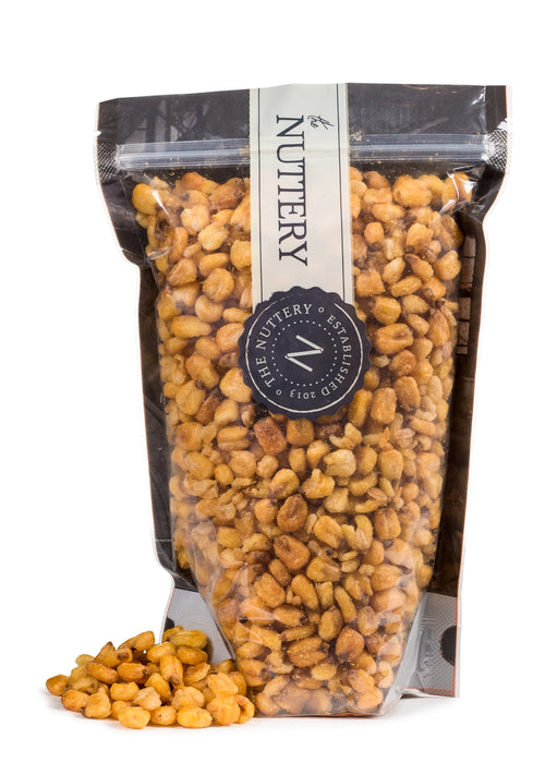 A resealable bag of crunchy, golden toasted corn nuts from The Nuttery, offering a bold and satisfying snack.