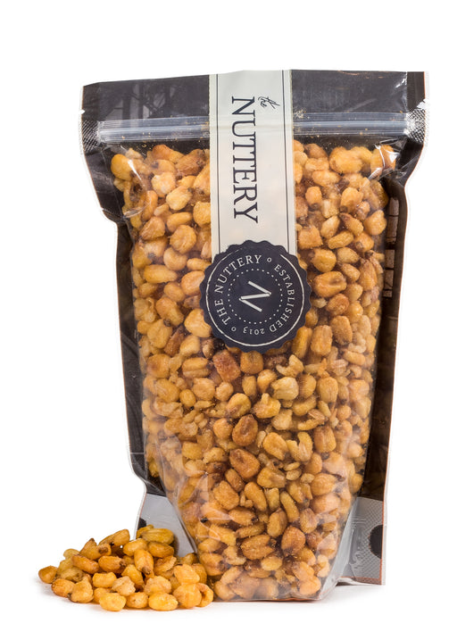A resealable bag of crunchy, golden toasted corn nuts from The Nuttery, offering a bold and satisfying snack.