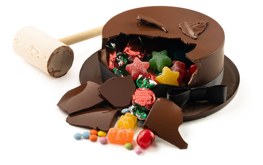 A festive hat cake, smashed and spill out even more candy! Wowza Goyza Batman!