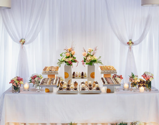 artisanal chocolates, gourmet nuts, and luxurious floral décor all set up for a wedding