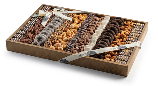Gourmet chocolate and nut gift tray with a variety of chocolate-dipped pretzels, nuts, and confectionery treats, elegantly arranged in a wooden box and wrapped with a Nuttery ribbon.