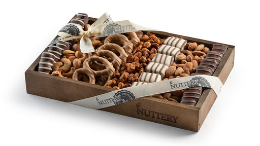 A gourmet selection of rich chocolates, roasted nuts, and crunchy confections in a wooden tray. Tied with an elegant ribbon, this gift is perfect for any occasion.