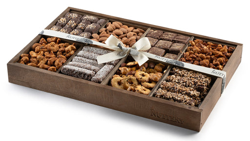 A premium chocolate and nut gift tray featuring an assortment of gourmet treats. Beautifully arranged and wrapped with a satin ribbon, this is a perfect gift for any occasion.