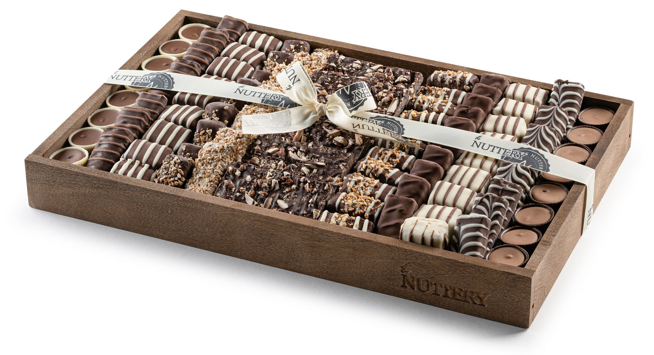 A sleek and sophisticated chocolate gift tray packed with rich, handcrafted confections. Tied with a satin ribbon, this elegant presentation makes for a perfect gift.